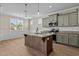 Modern kitchen with green cabinets, granite countertops, and stainless steel appliances at 147 Hillwood Dr, Sanford, NC 27332