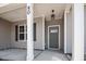 Front porch with gray door and white columns at 50 Oleander Ln, Sanford, NC 27332