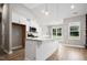 Kitchen with island, white cabinets, and stainless steel appliances at 50 Oleander Ln, Sanford, NC 27332