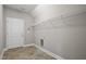 Laundry room with built-in shelving and tile flooring at 50 Oleander Ln, Sanford, NC 27332