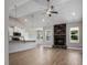 Open living room featuring a stone fireplace and high ceilings at 50 Oleander Ln, Sanford, NC 27332