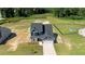 Aerial view of a two-story house with gray siding and stone accents, situated on a large lot at 83 Oleander Ln, Sanford, NC 27332