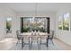 Bright dining room with modern table and chairs, and access to a deck overlooking the backyard at 1435 Duplin Rd, Raleigh, NC 27607