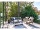 Relaxing deck features comfortable seating and a view of the lush trees at 1435 Duplin Rd, Raleigh, NC 27607