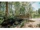 Wooden footbridge over a creek in a wooded area at 1435 Duplin Rd, Raleigh, NC 27607