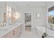 Elegant bathroom with double sinks, freestanding tub, and bedroom view at 1435 Duplin Rd, Raleigh, NC 27607