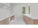 Bright laundry room with built-in cabinetry and workspace at 1435 Duplin Rd, Raleigh, NC 27607