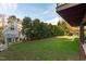 Landscaped backyard with grassy area and privacy hedge at 1435 Duplin Rd, Raleigh, NC 27607