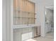 Basement bar with wet bar, wine cooler, and glass shelving at 1435 Duplin Rd, Raleigh, NC 27607