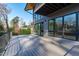 Modern deck with glass doors leading to the interior, showcasing a backyard view at 1439 Duplin Rd, Raleigh, NC 27607