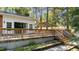 Wooden deck with railing, steps, and carport at 104 Lake Dr, Clayton, NC 27520