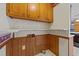 Laundry area with wooden cabinets and shelving at 104 Lake Dr, Clayton, NC 27520