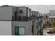 Exterior view of a modern townhouse with a rooftop deck and city views at 2014 Moody Ln, Durham, NC 27701