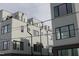 Exterior view of modern townhouses with gray siding and rooftop decks at 2014 Moody Ln, Durham, NC 27701