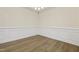 Dining room corner with hardwood floors and wainscoting at 304 Ford Meadows Dr, Garner, NC 27529