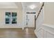 Formal dining room with hardwood floors, wainscoting, and large window at 304 Ford Meadows Dr, Garner, NC 27529