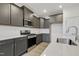 Modern kitchen with dark gray cabinets and a large island at 304 Ford Meadows Dr, Garner, NC 27529