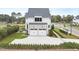 Backyard view of the home with two-car garage and landscaped yard at 3401 Makers Cir, Raleigh, NC 27612