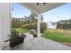 Back patio with outdoor dining area and view of lush landscaping and trees at 3401 Makers Cir, Raleigh, NC 27612