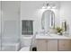 Modern bathroom with light wood vanity, white countertop, and gold fixtures at 3401 Makers Cir, Raleigh, NC 27612
