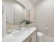 Bathroom with white marble vanity, gold fixtures, and decorative tile floor at 3401 Makers Cir, Raleigh, NC 27612