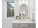 Bathroom with a gold-framed mirror, contemporary vanity, and large window at 3401 Makers Cir, Raleigh, NC 27612
