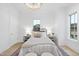 Bright bedroom with light walls and floors, simple furnishings, and large windows at 3401 Makers Cir, Raleigh, NC 27612