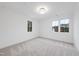 Empty bedroom with carpet flooring, white walls, and multiple windows at 3401 Makers Cir, Raleigh, NC 27612