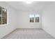 Empty bedroom with carpet flooring, white walls, and multiple windows at 3401 Makers Cir, Raleigh, NC 27612