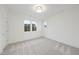 Empty bedroom with carpet flooring and multiple windows at 3401 Makers Cir, Raleigh, NC 27612