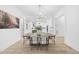 Dining room with modern chandelier and view into the kitchen at 3401 Makers Cir, Raleigh, NC 27612