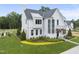 Charming white two-story home with a landscaped yard and a welcoming walkway at 3401 Makers Cir, Raleigh, NC 27612