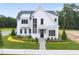 A white, two-story house with black trim and a gray roof at 3401 Makers Cir, Raleigh, NC 27612