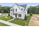 White two-story home with landscaped front yard at 3401 Makers Cir, Raleigh, NC 27612
