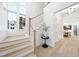 Bright foyer with wood staircase, hardwoods floors, and natural light at 3401 Makers Cir, Raleigh, NC 27612