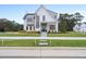 Modern two-story white farmhouse with black trim and a large front yard at 3401 Makers Cir, Raleigh, NC 27612
