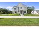 Inviting white two-story home with black accents, lush lawn, and welcoming entryway at 3401 Makers Cir, Raleigh, NC 27612