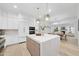 Bright, spacious kitchen featuring a large island, white cabinets, and stainless steel appliances at 3401 Makers Cir, Raleigh, NC 27612