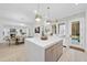 Open concept kitchen and dining area with large island and hardwood floors at 3401 Makers Cir, Raleigh, NC 27612
