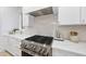 Modern kitchen with stainless steel appliances and white cabinetry at 3401 Makers Cir, Raleigh, NC 27612