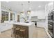 Modern kitchen featuring white cabinets, marble countertops, and gold accents at 3401 Makers Cir, Raleigh, NC 27612