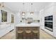 Sleek white kitchen with large island, stainless steel appliances, and gold accents at 3401 Makers Cir, Raleigh, NC 27612