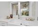 Farmhouse sink in kitchen with window view and quartz countertops at 3401 Makers Cir, Raleigh, NC 27612