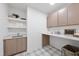 Laundry room with cabinets, sink, and plaid floor at 3401 Makers Cir, Raleigh, NC 27612