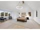 Spacious main bedroom with vaulted ceiling, chandelier, and hardwood floors at 3401 Makers Cir, Raleigh, NC 27612