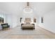 Spacious main bedroom with vaulted ceiling, wood floors, and stylish chandelier at 3401 Makers Cir, Raleigh, NC 27612