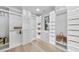 Large organized walk-in closet with lots of built-ins and natural light at 3401 Makers Cir, Raleigh, NC 27612