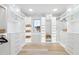 Spacious, well-lit walk-in closet with built-in shelving, drawers, and center island at 3401 Makers Cir, Raleigh, NC 27612