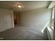 Bedroom featuring carpet, double door closet and window at 323 Chestnut Oak Ln, Lillington, NC 27546