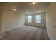 Bright bedroom with carpeted floors and multiple windows at 323 Chestnut Oak Ln, Lillington, NC 27546